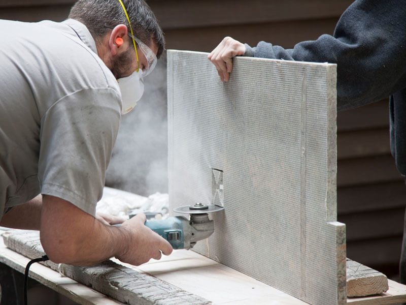 guy cutting granite with saw