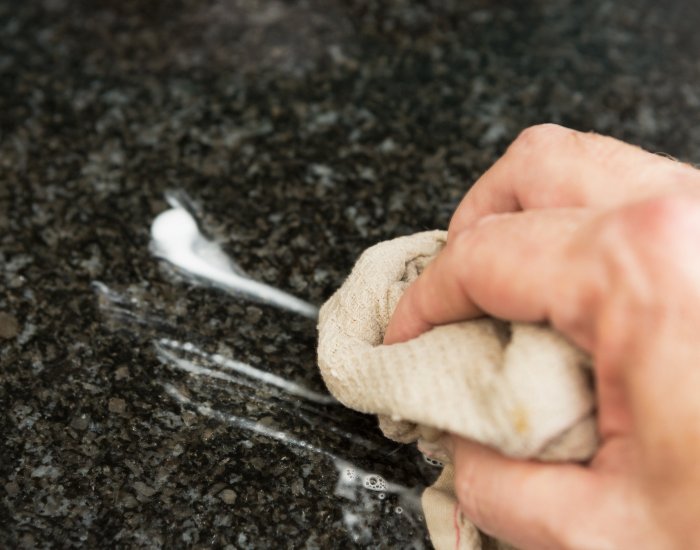 A person cleaning a Granite Countertops in Utah County, UT 