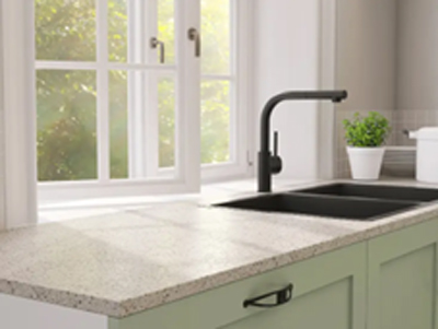 A granite countertop paired with light green cabinets in Springville, UT.