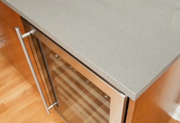 Close-up of a countertop overhang edge above cabinetry in a modern kitchen