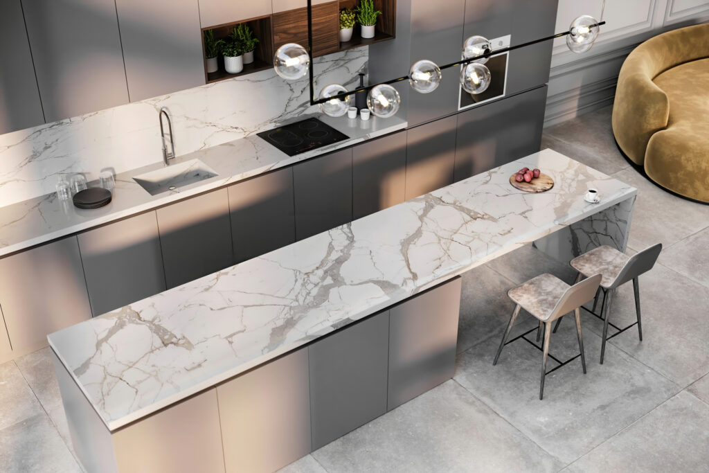Modern kitchen with a white marble countertop featuring intricate grey veining, paired with dark grey cabinetry, a sleek island, and a contemporary chandelier, showcasing luxurious marble finishes and textures