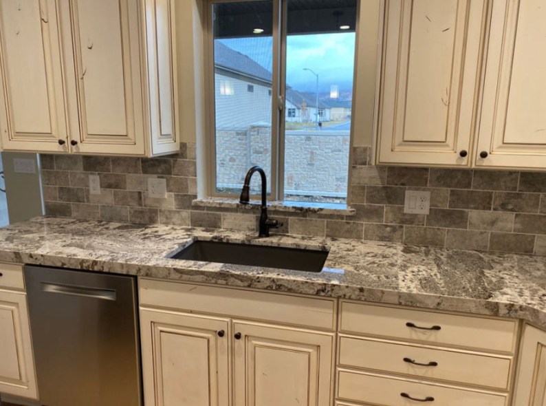 Tile backsplash installation in modern kitchen by Signature Marble and Granite