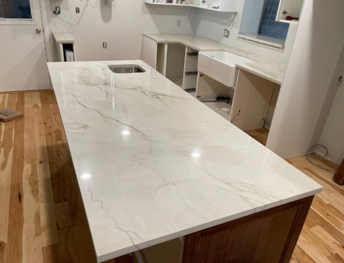 Quartzite kitchen island with waterfall edge and integrated sink