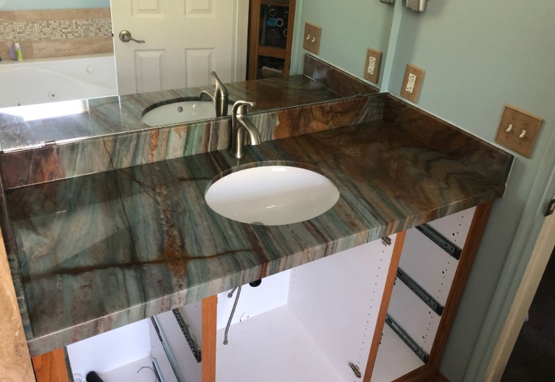 Custom quartzite bathroom vanity countertop with integrated backsplash