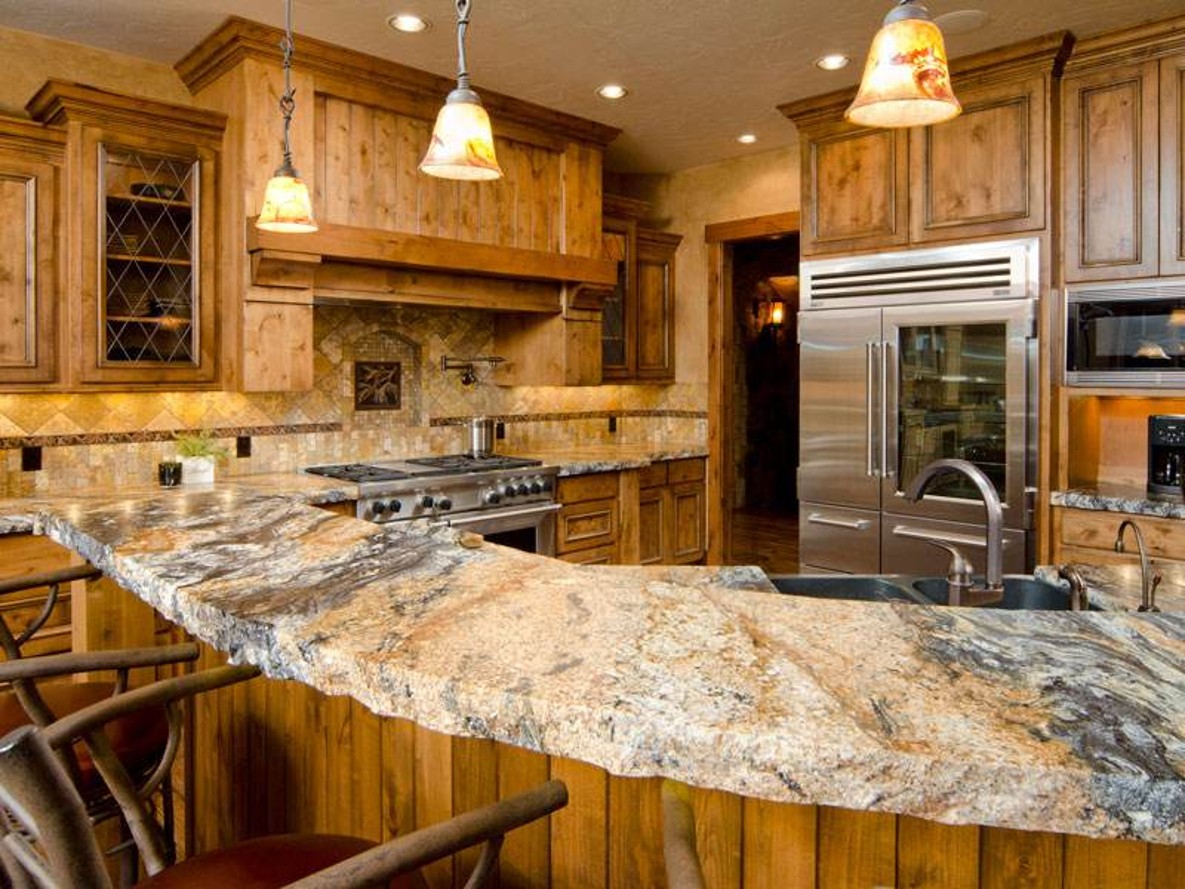 Granite countertop island in a rustic kitchen with natural stone patterns