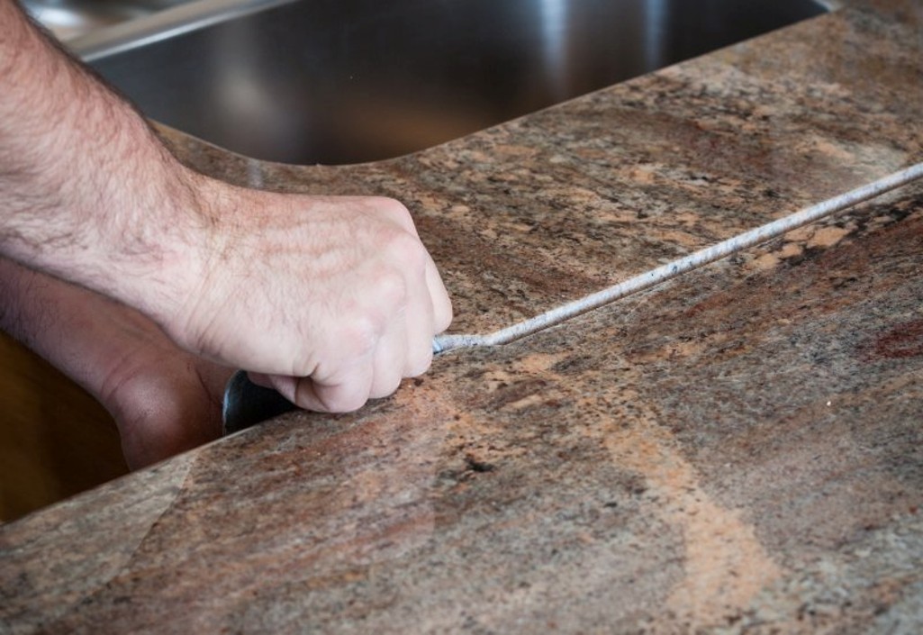 Close-up of a granite countertop seam installation near an undermount sink