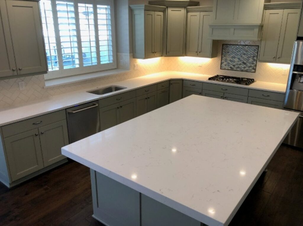 Polished white quartz countertop island in a modern residential kitchen